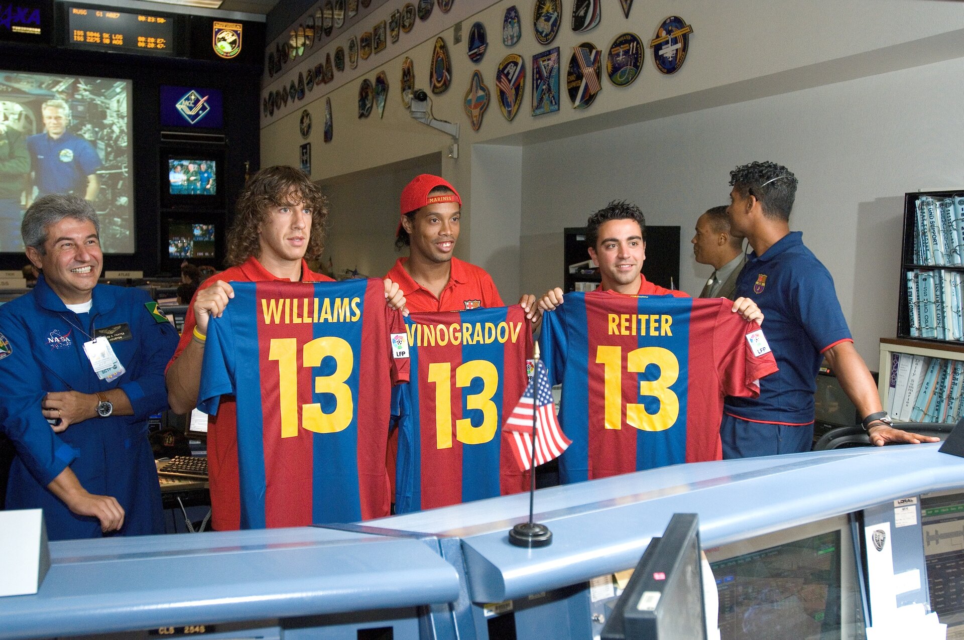Puyol, Ronaldinho and Xavi hold personalised FC Barcelona shirts presented to Expedition 13