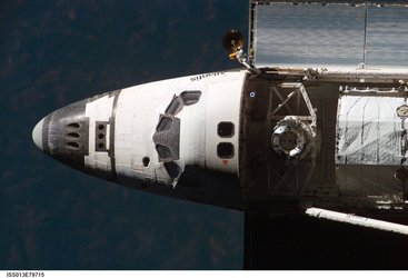 Image of the Space Shuttle approaching the orbital outpost