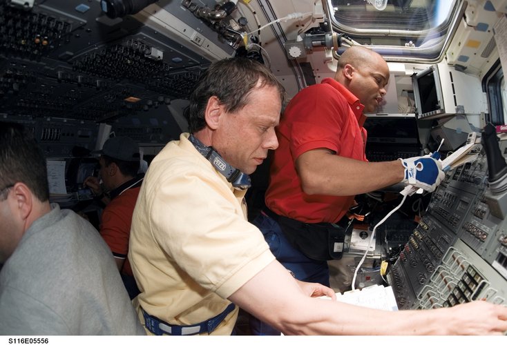Christer Fuglesang and Robert Curbeam at work on board the Space Shuttle