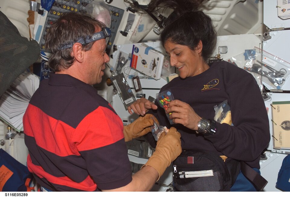 Even simple tasks get complicated in weightlessness - here Christer Fuglesang and Sunita Williams prepare a meal