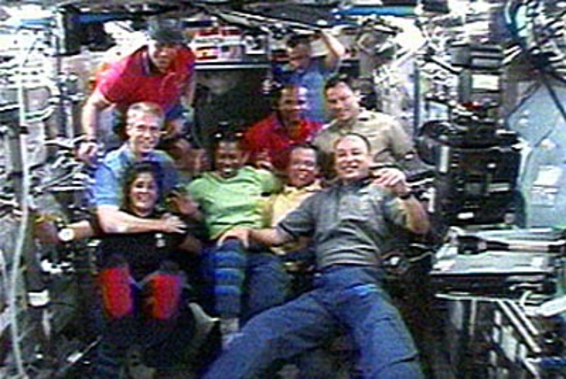 The Expedition 14 and STS-116 crews inside ISS shortly after hatch opening