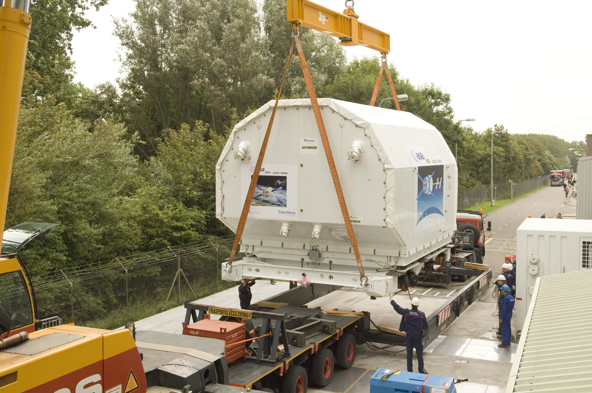 ATV transportation containers are loaded onto trucks outside the ESTEC Test Centre