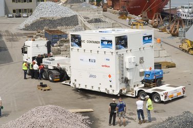 The containers are placed on the trucks which have also arrived at Rotterdam harbour