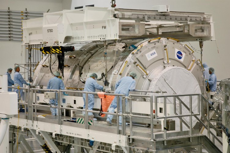 Technicians attach an overhead crane to the U.S. Node 2 module