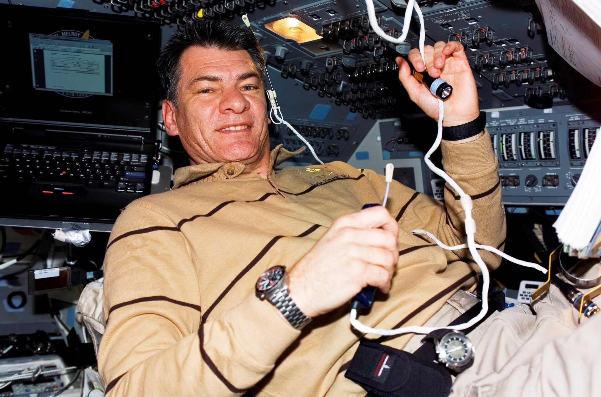 Paolo Nespoli uses communication system on the Shuttle flight deck