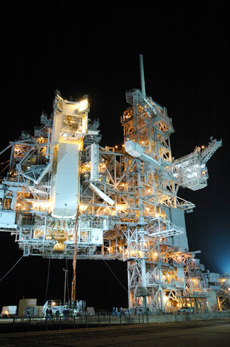 Payload canister holding Columbus is lifted up toward the payload changeout room on Launch Pad 39A