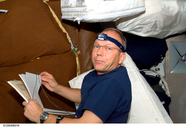 ESA astronaut Hans Schlegel works in Shuttle middeck
