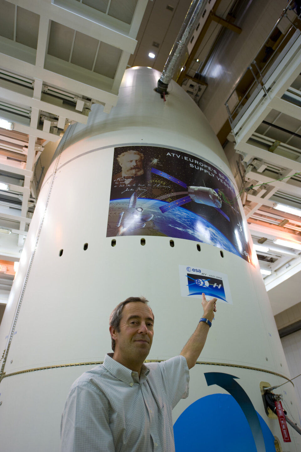 Jean-François Clervoy points to stickers on the Ariane 5 ES-ATV launcher fairing