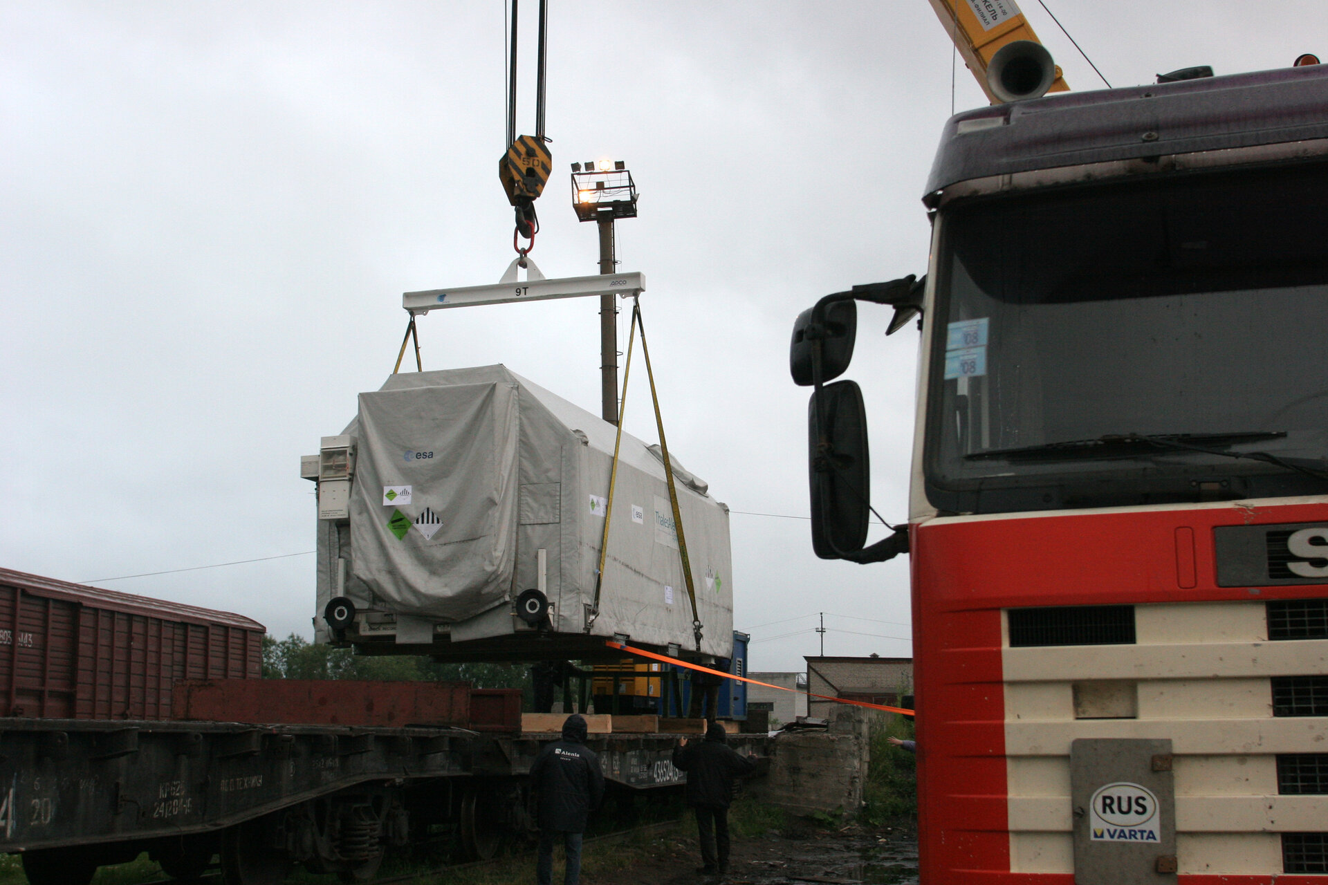 Spacecraft being moved from truck to train