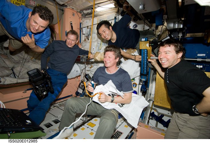 Expedition 20 crewmembers gather for a celebration of Father's day and a birthday