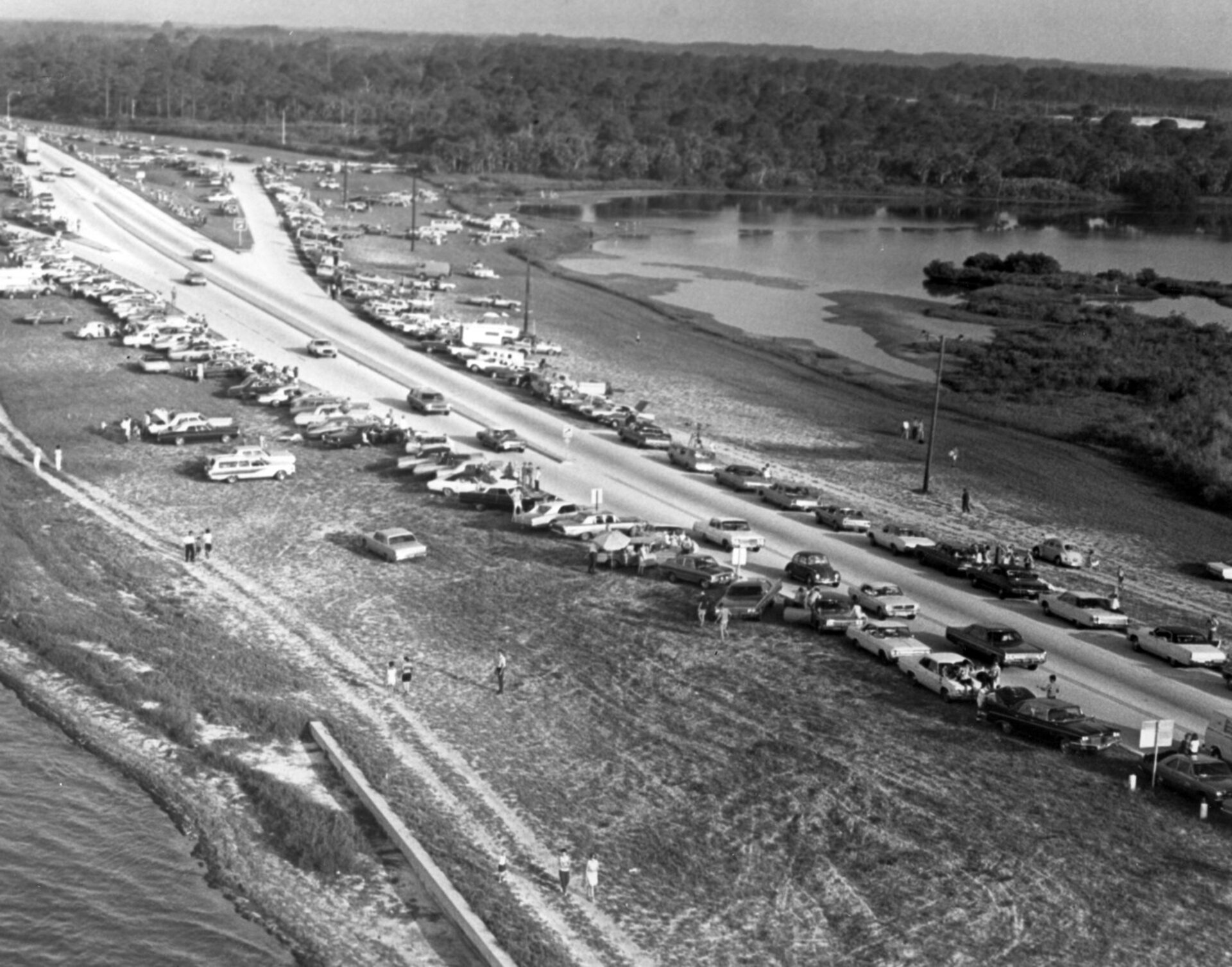 Spectators line roads and beaches