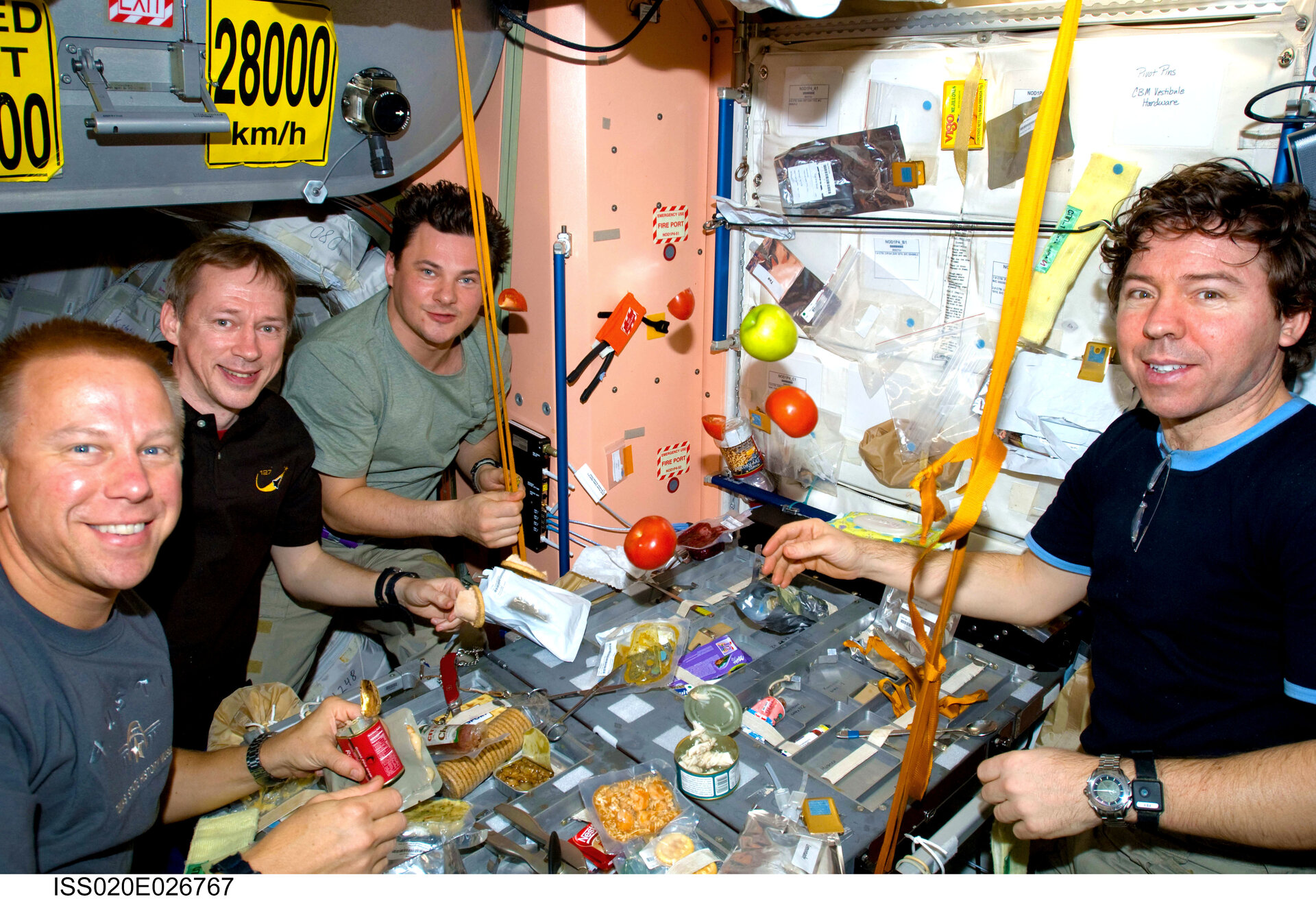 Expedition 20 crewmembers share a meal at the galley in Unity