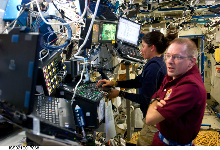 Frank De Winne and Nicole Stott at Canadarm2 workstation for unberthing of HTV