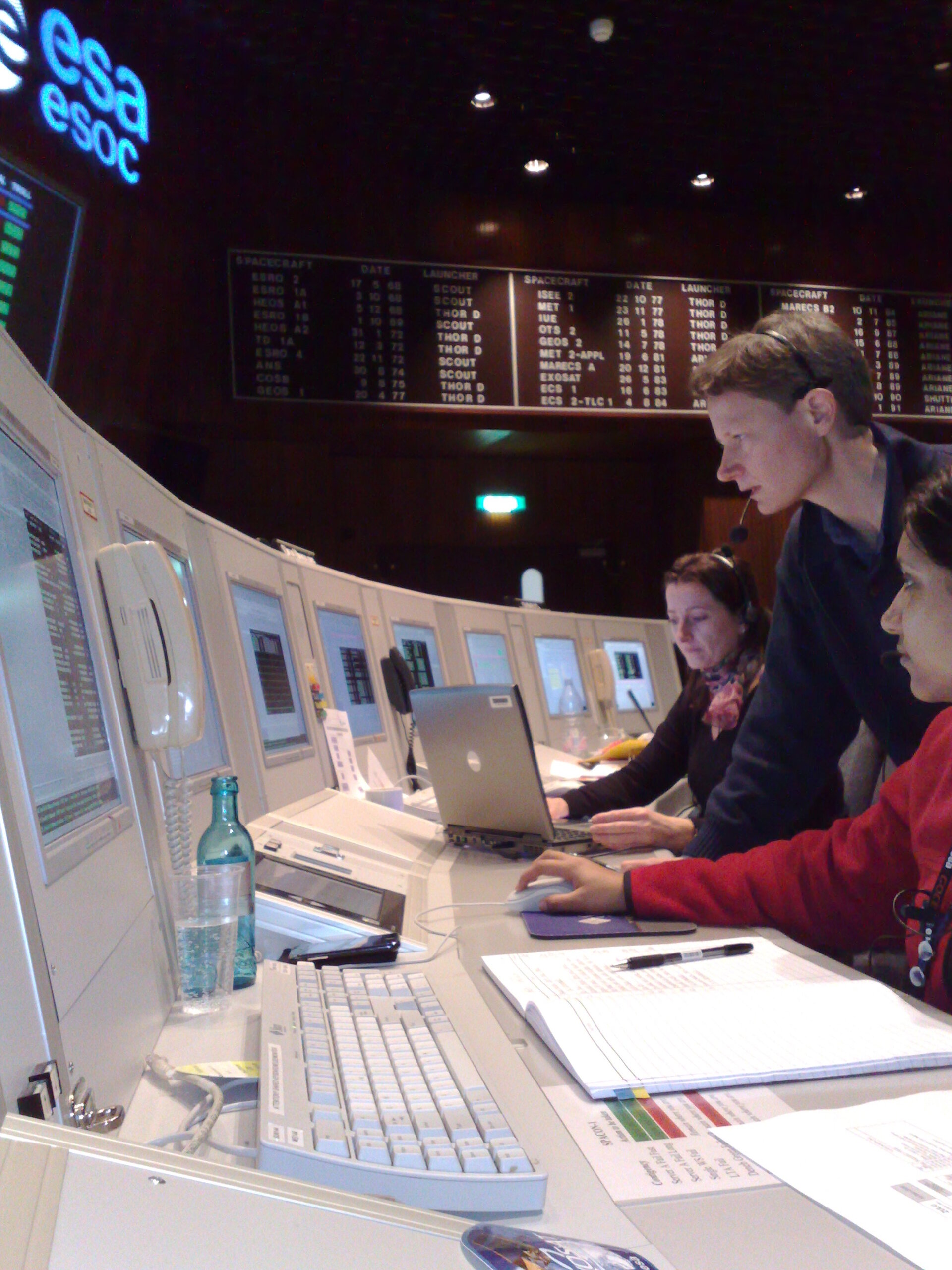 Spacecraft Operations Manager Nic Mardle (standing) on console with flight team members