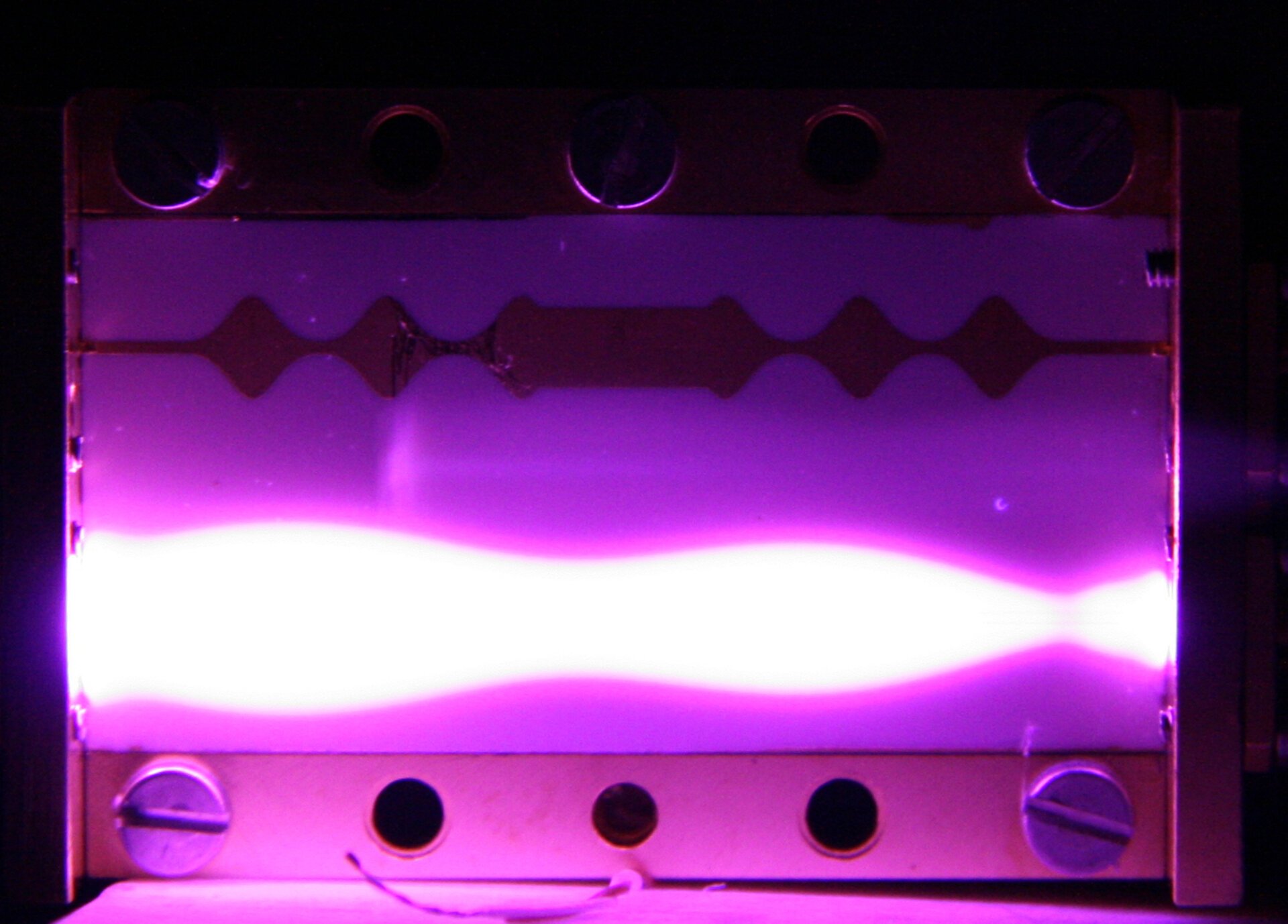 Corona discharge glow in a microstrip RF component tested at ESTEC