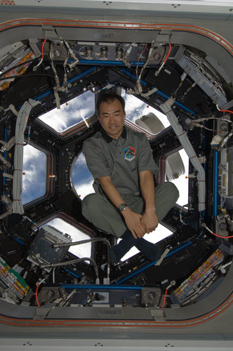 Soichi Noguchi poses near the windows in the Cupola