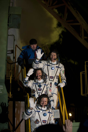 Soyuz TMA-20 crew greeting audience at the launch pad