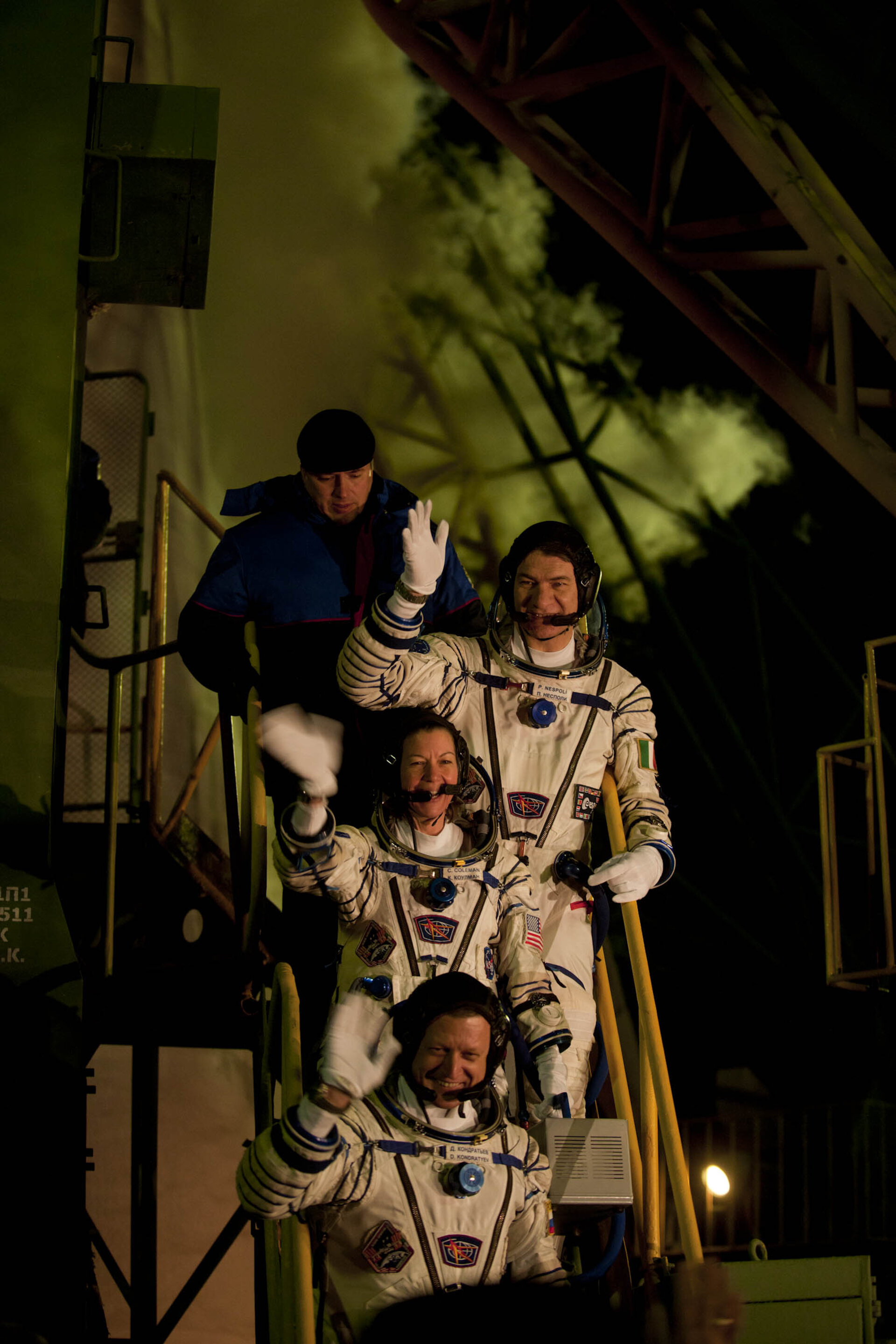 Soyuz TMA-20 crew greeting audience at the launch pad