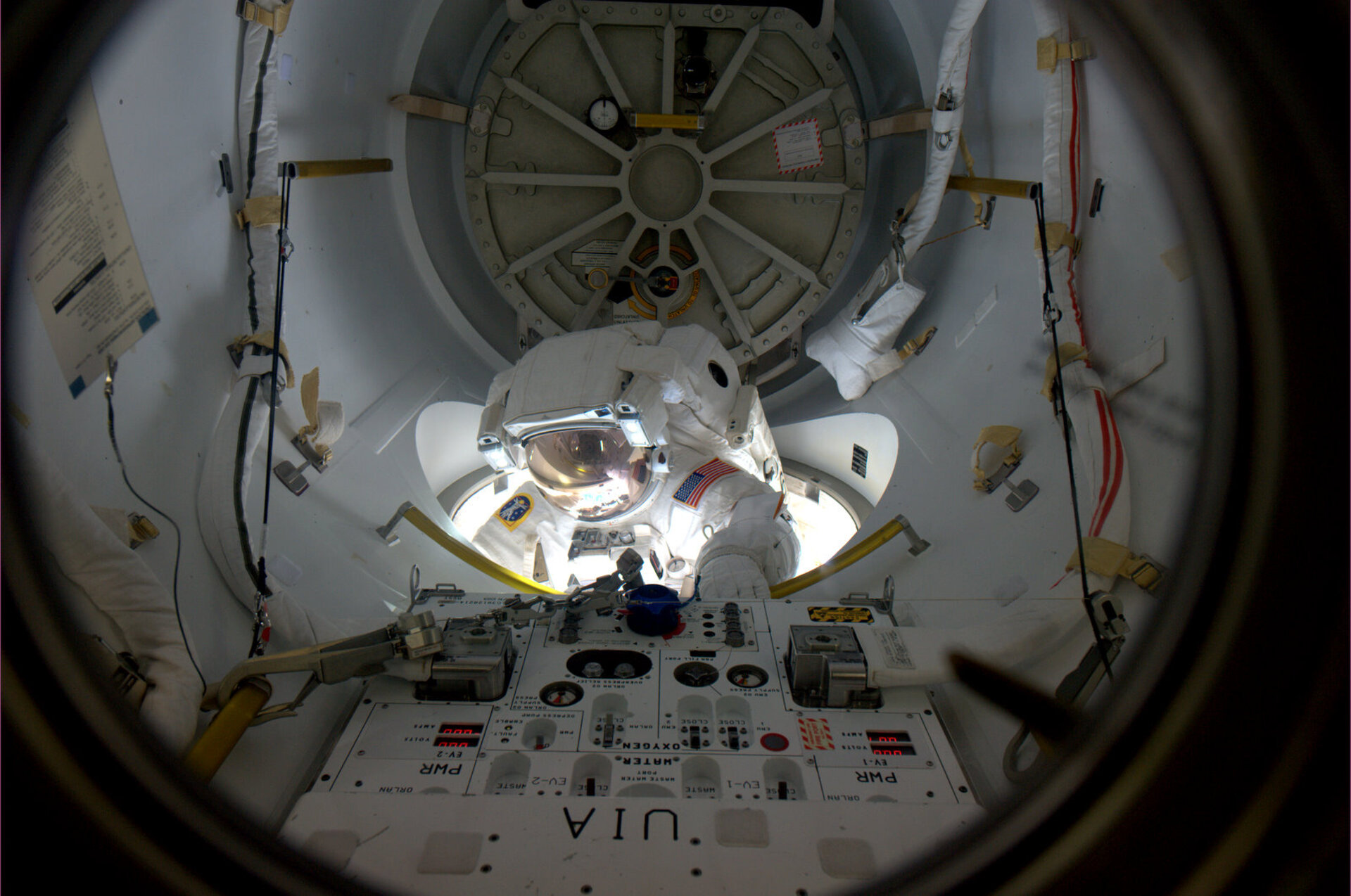 Al Drew half way through the ISS airlock