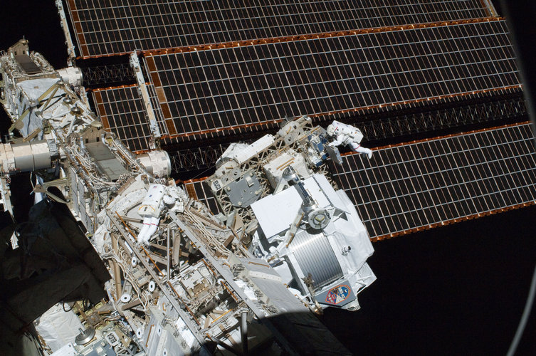 AMS-02 with EVA astronauts in the background