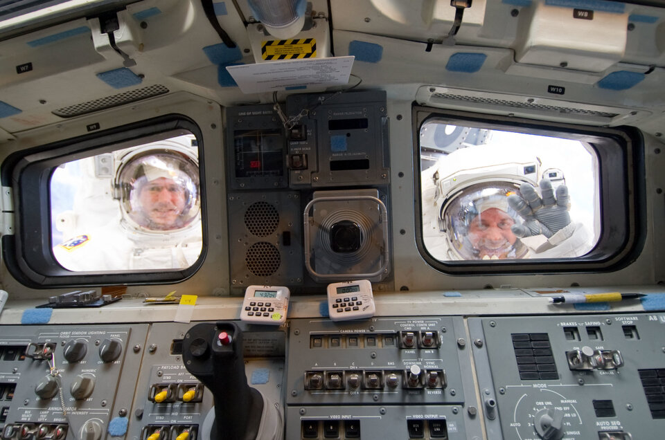 Spacewalkers in aft flight deck windows of <i>Atlantis</i> in last May