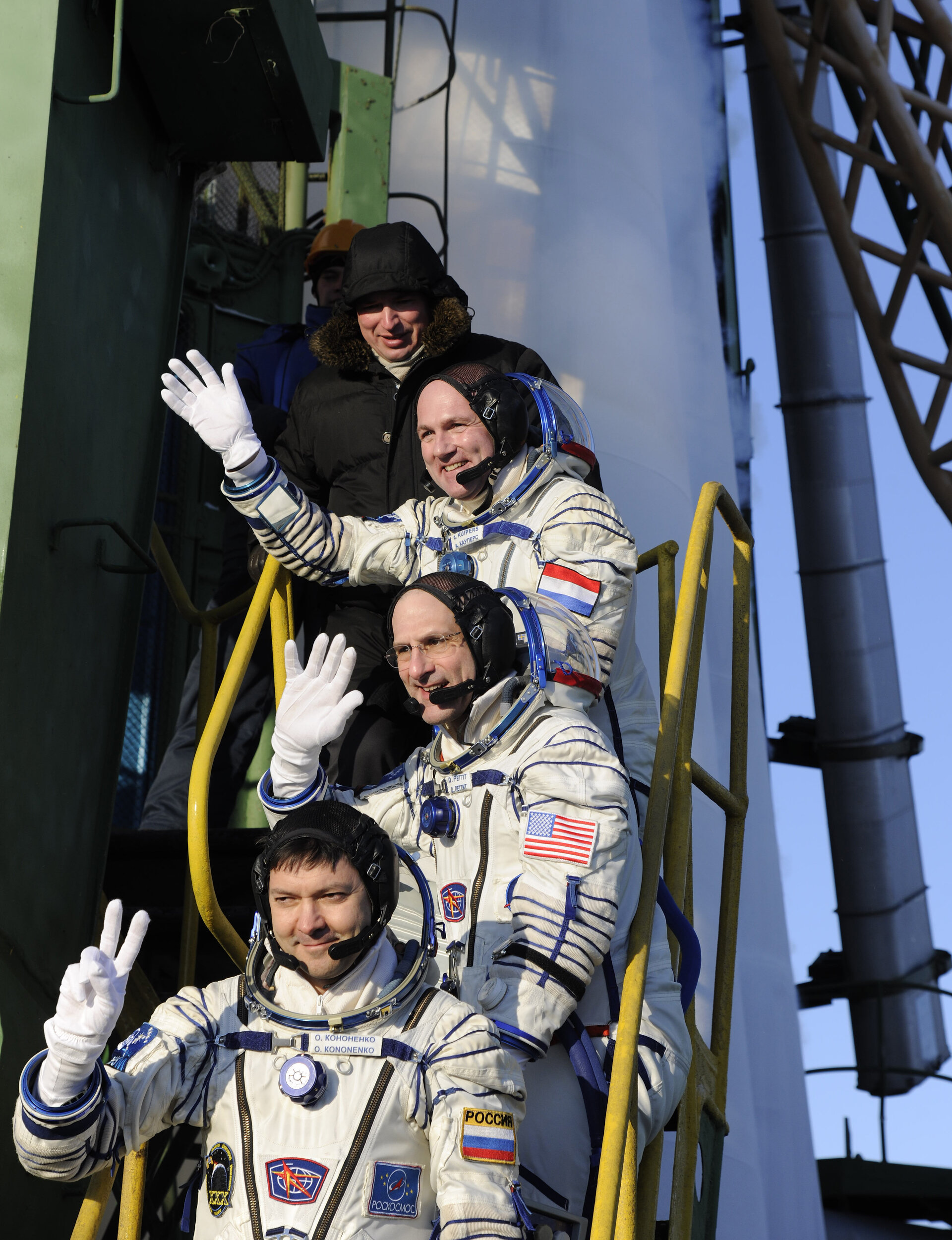 Expeditions 30 and 31 crew members greeting audience at the launch pad