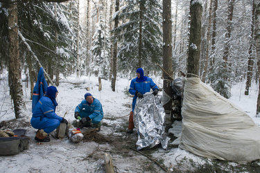Building a shelter during winter survival training