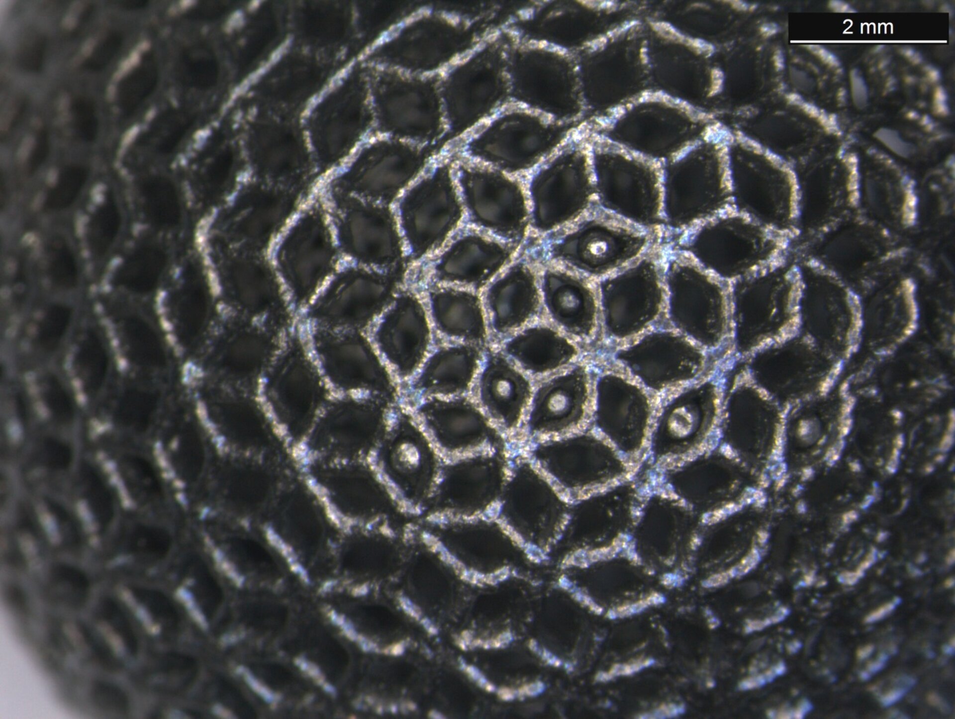 Close-up of 3D-printed titanium lattice ball