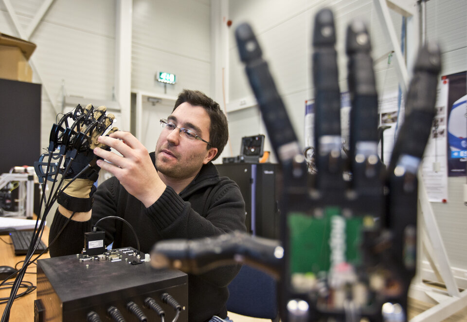 When the ESA engineer moves his gauntleted hand, the robotic hand follows in sync