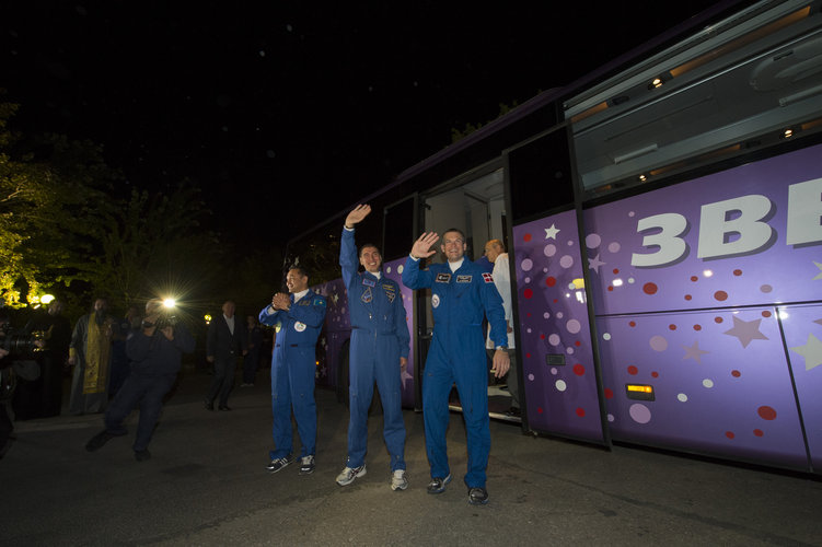 Soyuz TMA-18M crew members wave farewell to family and friends