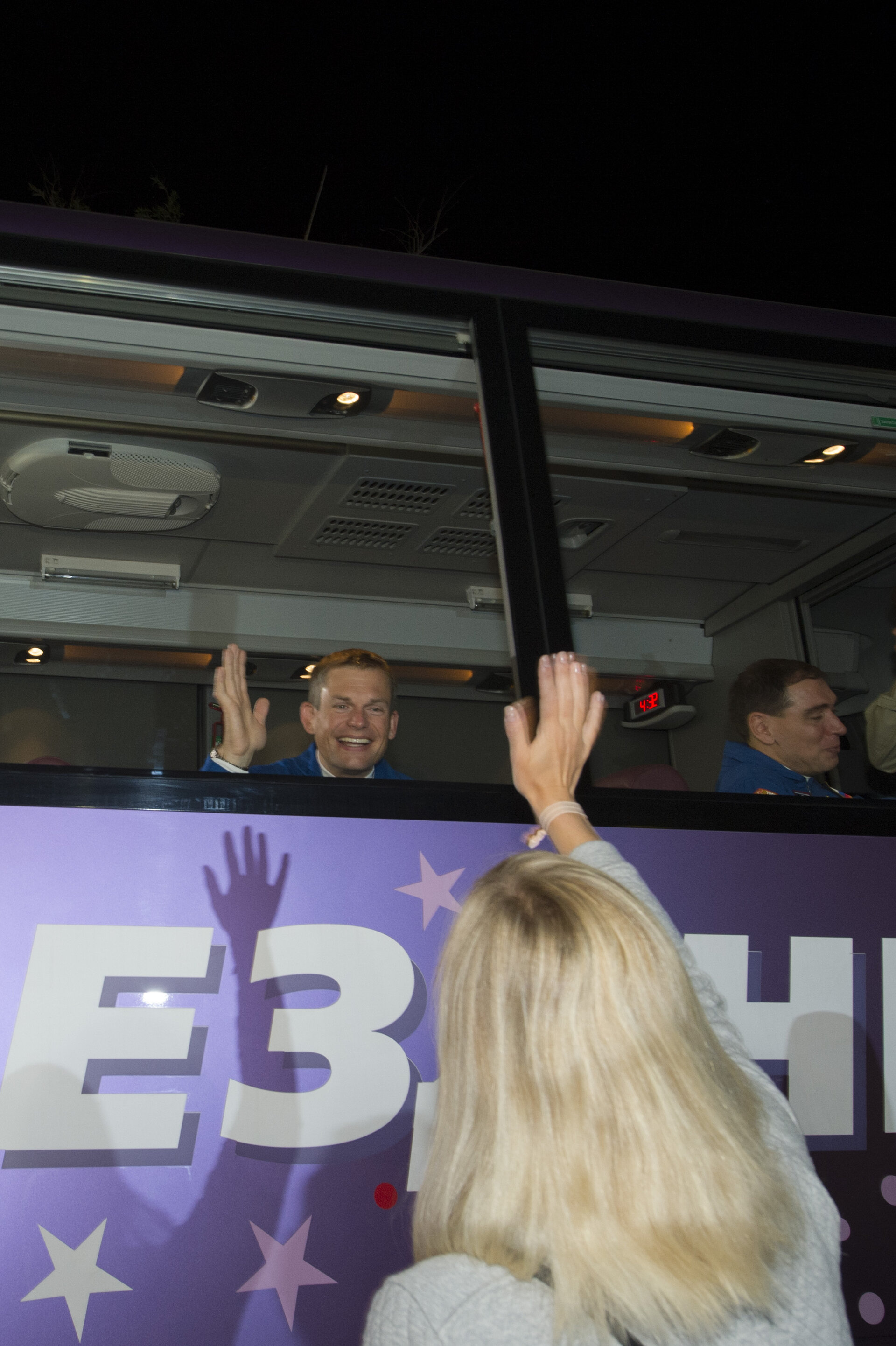 Soyuz TMA-18M crew members wave farewell to family and friends