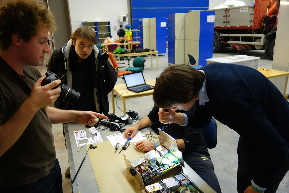 Team CPT-SCOPE examining their experiment after flight