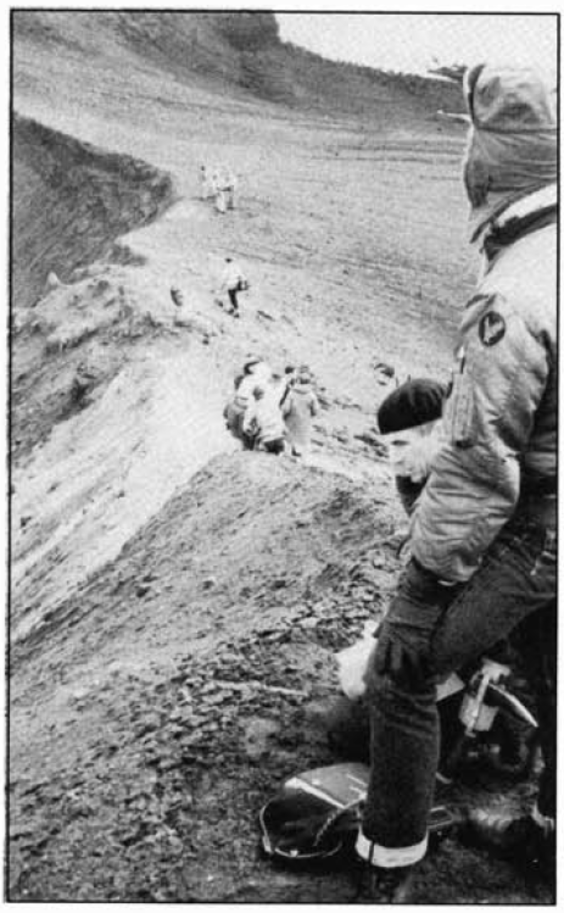 Apollo astronauts on the steep rim of a small volcanic crater in Iceland