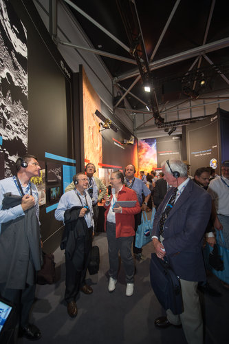 Isabelle Duvaux-Béchon shows AA-IHEDN representives the ESA Pavilion