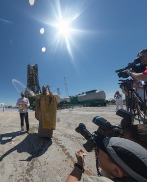 An Orthodox Priest blesses members of the media 