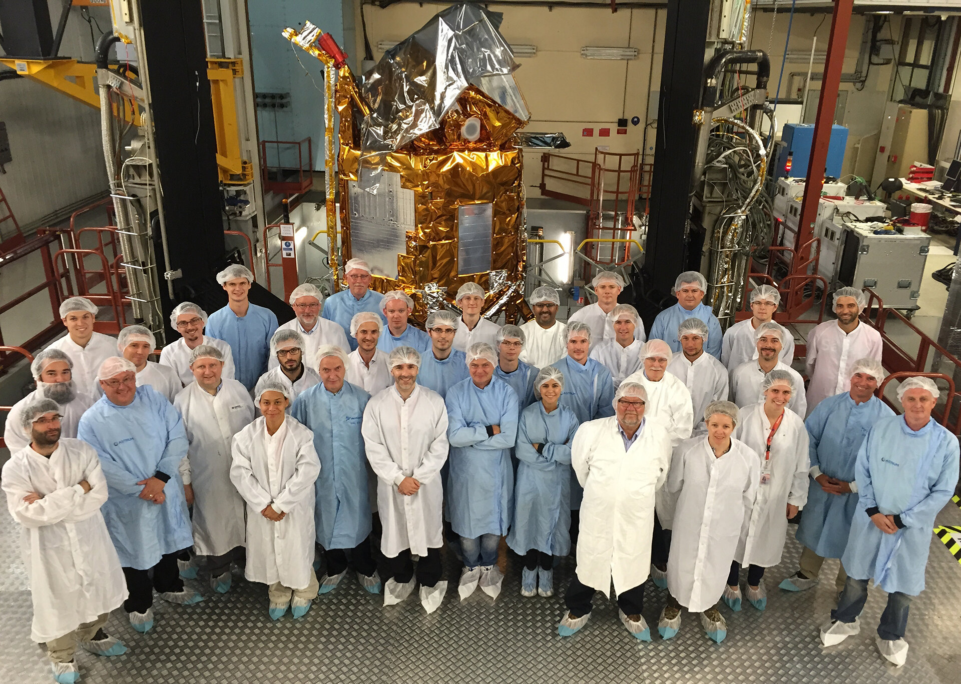Sentinel-5P is in the background, behind lots of mission scientists and engineers