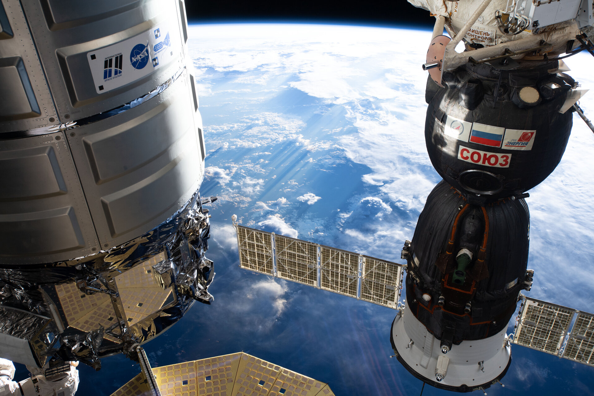 Cygnus space freighter and the Soyuz MS-12 crew ship