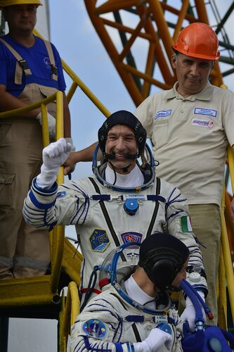 Soyuz MS-13 crew wave from the steps to their Soyuz MS-13 spacecraft