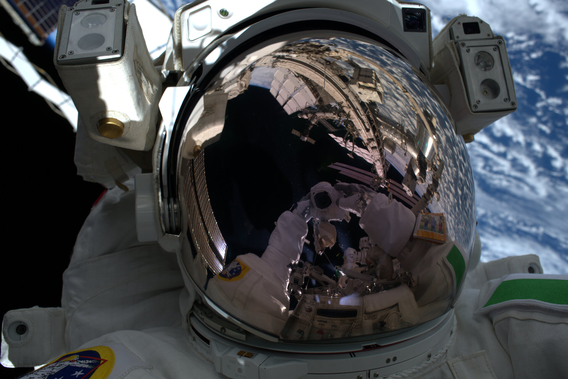Luca removes fasteners by helmet light during first AMS spacewalk