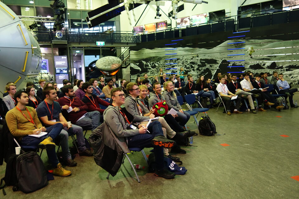 Teams watch as one team presents their project proposal