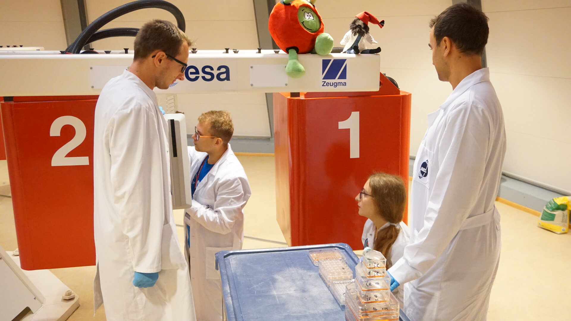 Students removing their life sciences experiment from the gondola