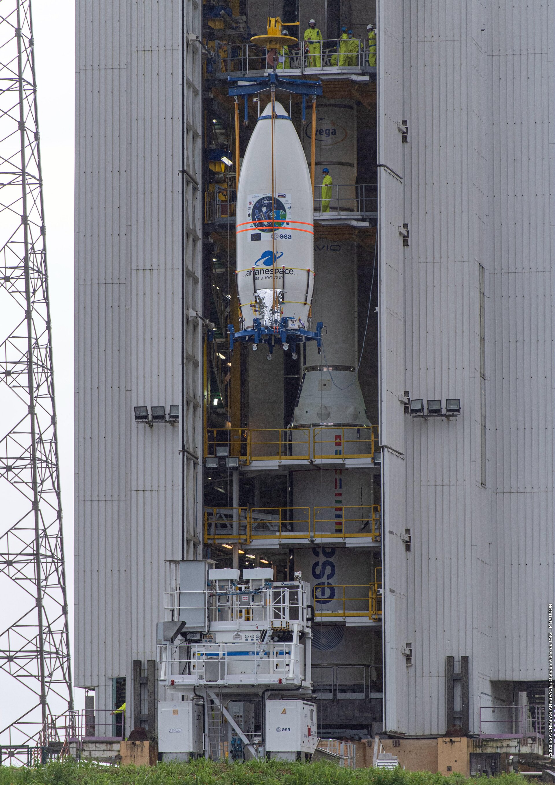 Vega's ridesharing satellites secured on the SSMS dispenser inside the fairing are hoisted to the top of the mobile gantry at Europe's Spaceport.