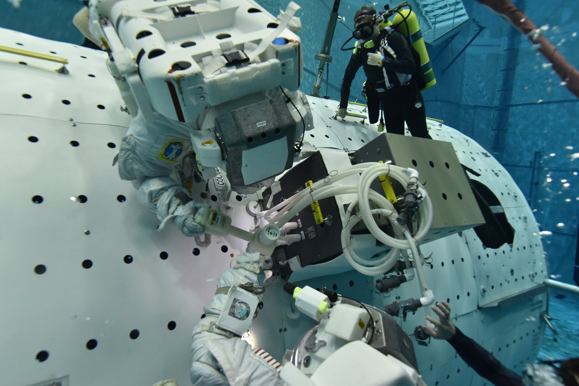 Astronauts training at NASA’s Neutral Buoyancy Laboratory for the installation of the ColKa device