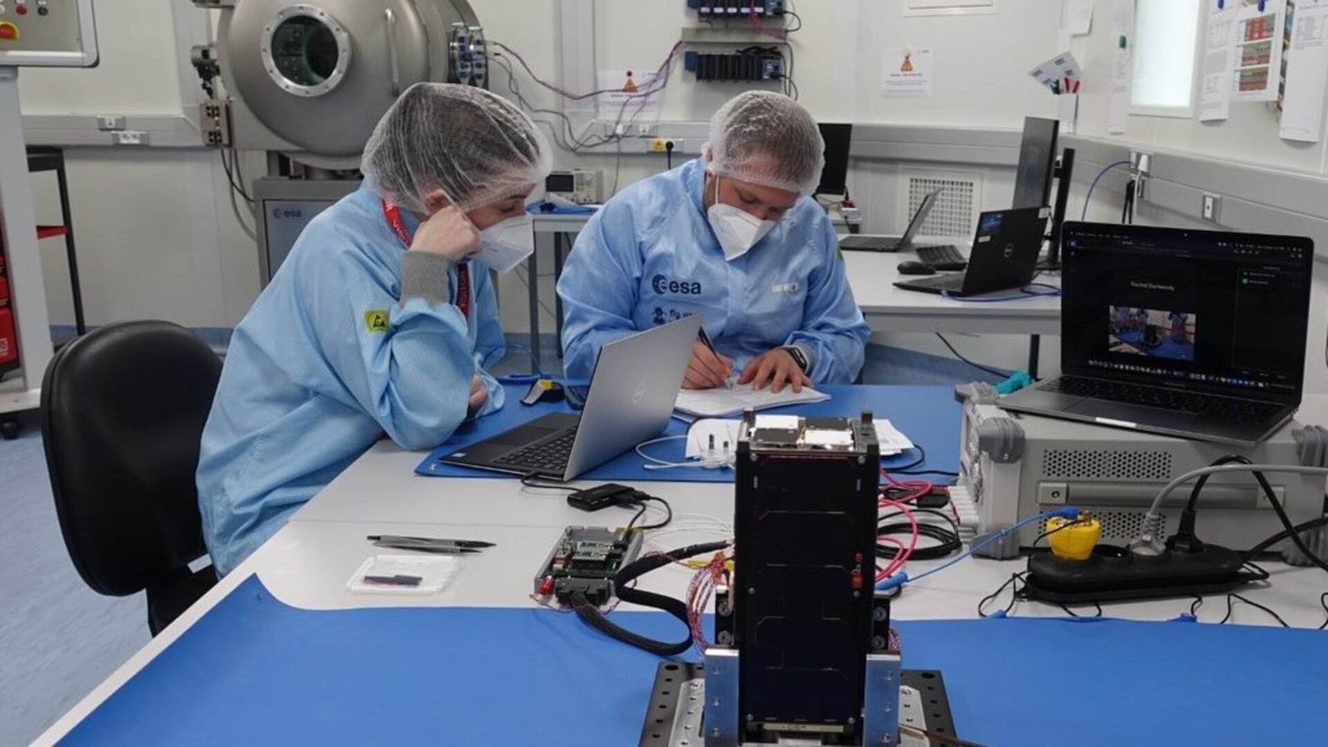 Students from the EIRSAT team performing functional checks in the CubeSat Support Facility.