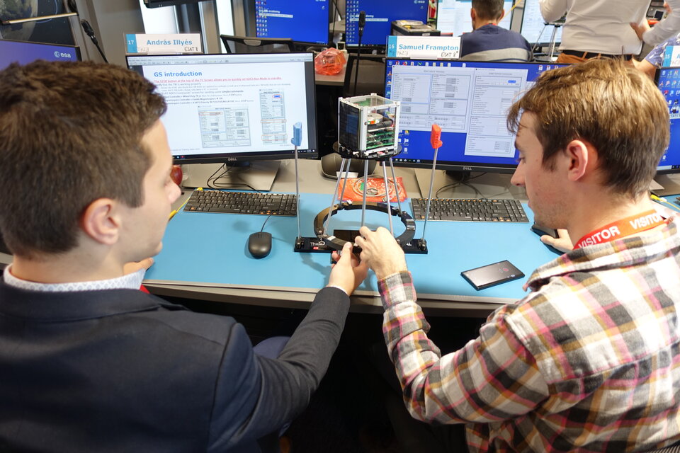 Students performing experiments on their ESAT model.