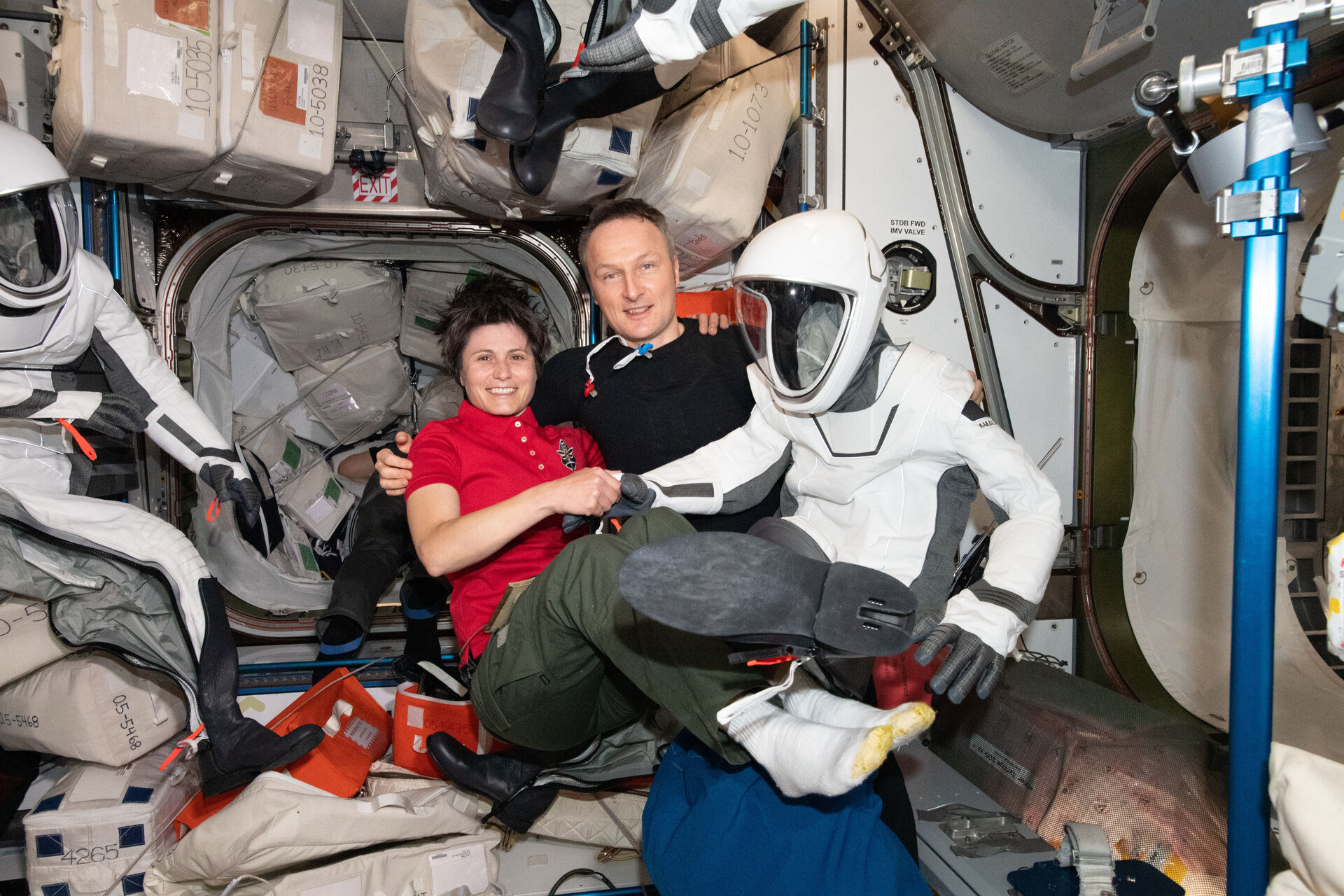 Samantha and Matthias with a SpaceX spacesuit in orbit