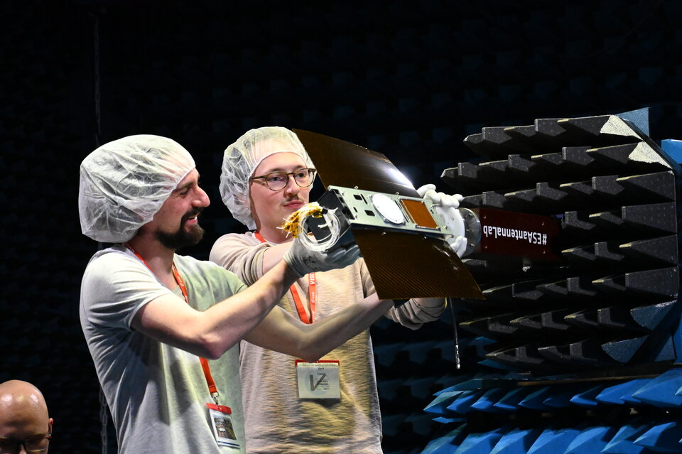 Students installing their CubeSat at the antenna test range.