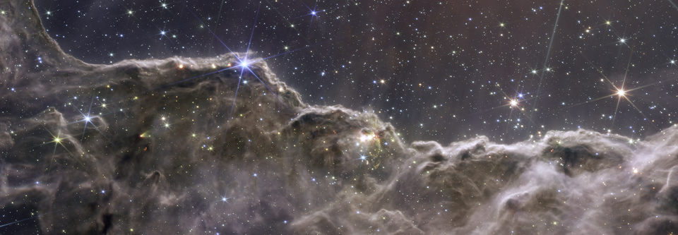 MIRI and NIRCam reveal a landscape of star forming mountains and valleys in the Carina Nebula.