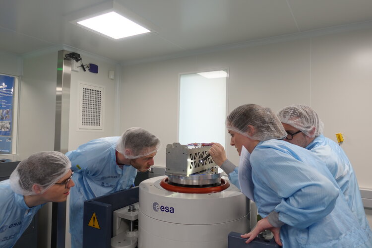 EIR team inspecting their satellite after it has given a shake