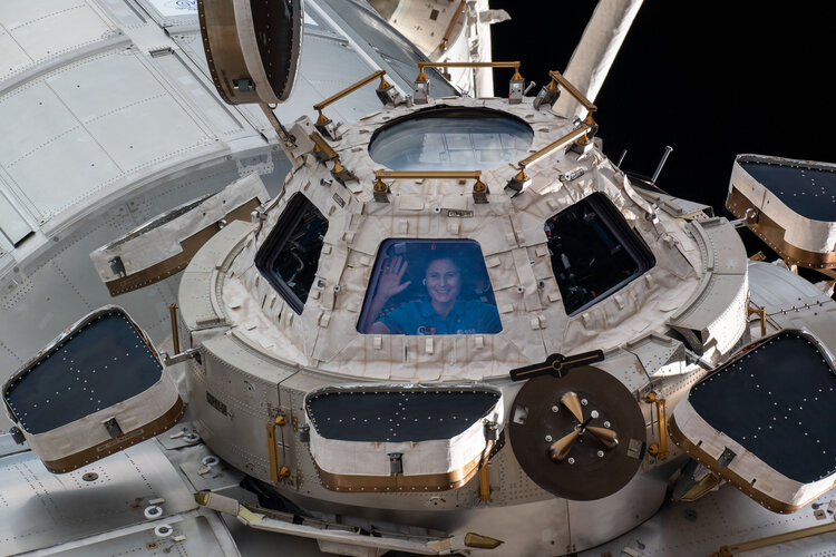 ESA astronaut Samantha Cristoforetti looks out from a window on the cupola